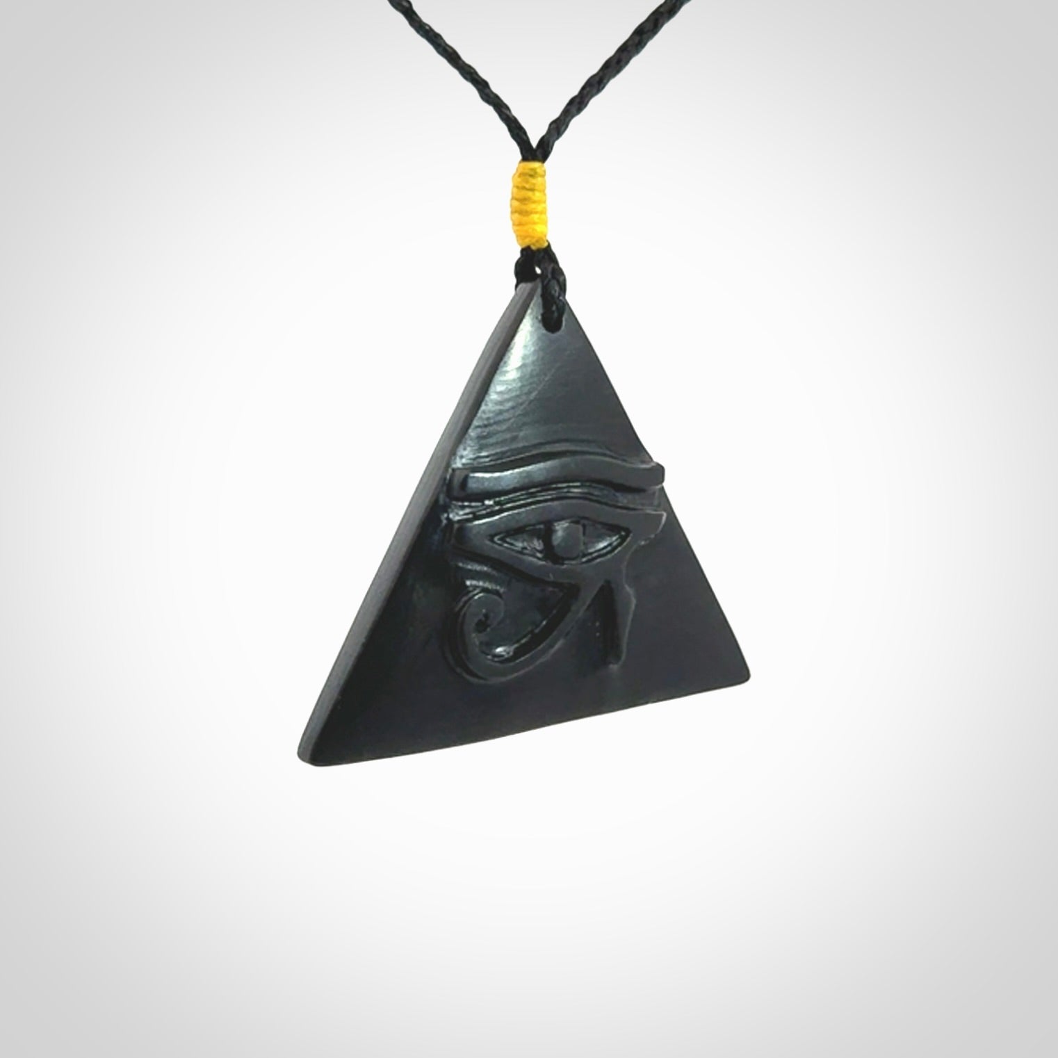 An Egyptian Eye of Ra pyramid pendant, hand made for us from Australian Black Jade. This pendant is provided with an adjustable black cord.