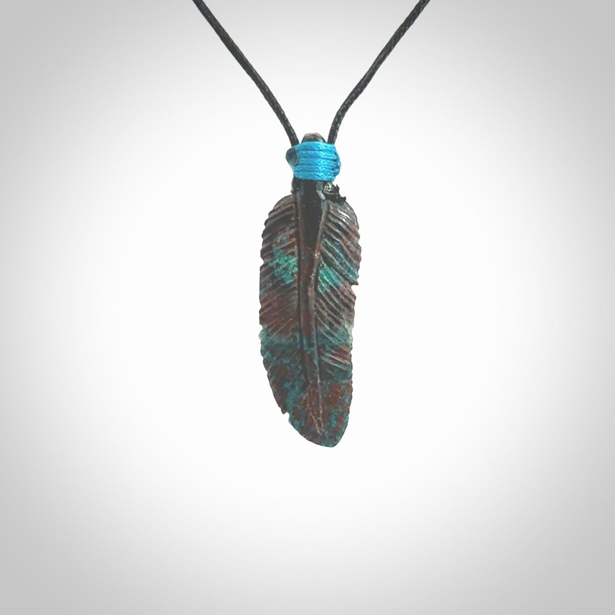 This is a hand carved feather pendant made from a gorgeous and striking piece of African Turquoise stone. For sale online from NZ Pacific. Delivered with adjustable black cord.
