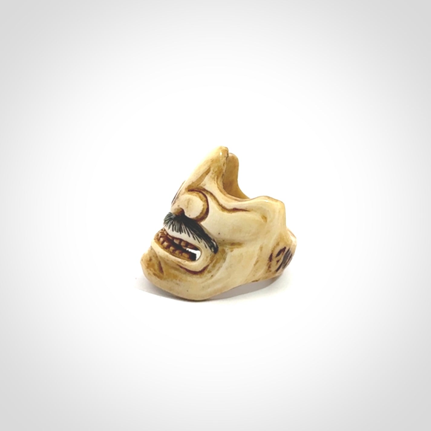 Hand carved Menpo samurai face guard ring. Made from Red Deer antler in New Zealand. Hand made from deer antler by master bone carver Fumio Noguchi. Spectacular collectable work of art, made to wear. One only ring, delivered to you with express courier.