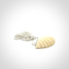 Hand made woolly mammoth tusk fanshell necklace with Sterling Silver. Mammoth tusk fanshell pendant with Sterling silver surround and chain. Made by NZ Pacific and sale online only.