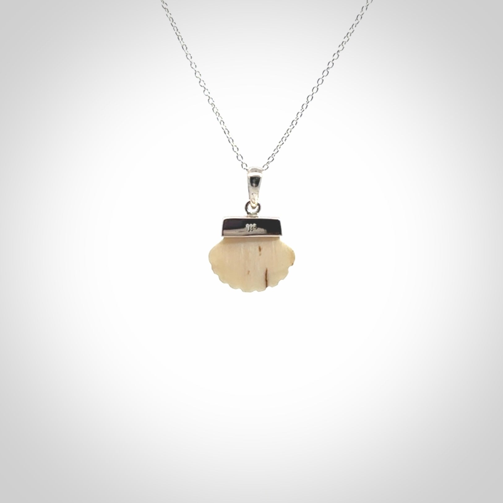 Hand made woolly mammoth tusk fanshell necklace with Sterling Silver. Mammoth tusk fanshell pendant with Sterling silver surround and chain. Made by NZ Pacific and sale online only.