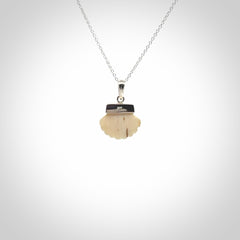 Hand made woolly mammoth tusk fanshell necklace with Sterling Silver. Mammoth tusk fanshell pendant with Sterling silver surround and chain. Made by NZ Pacific and sale online only.