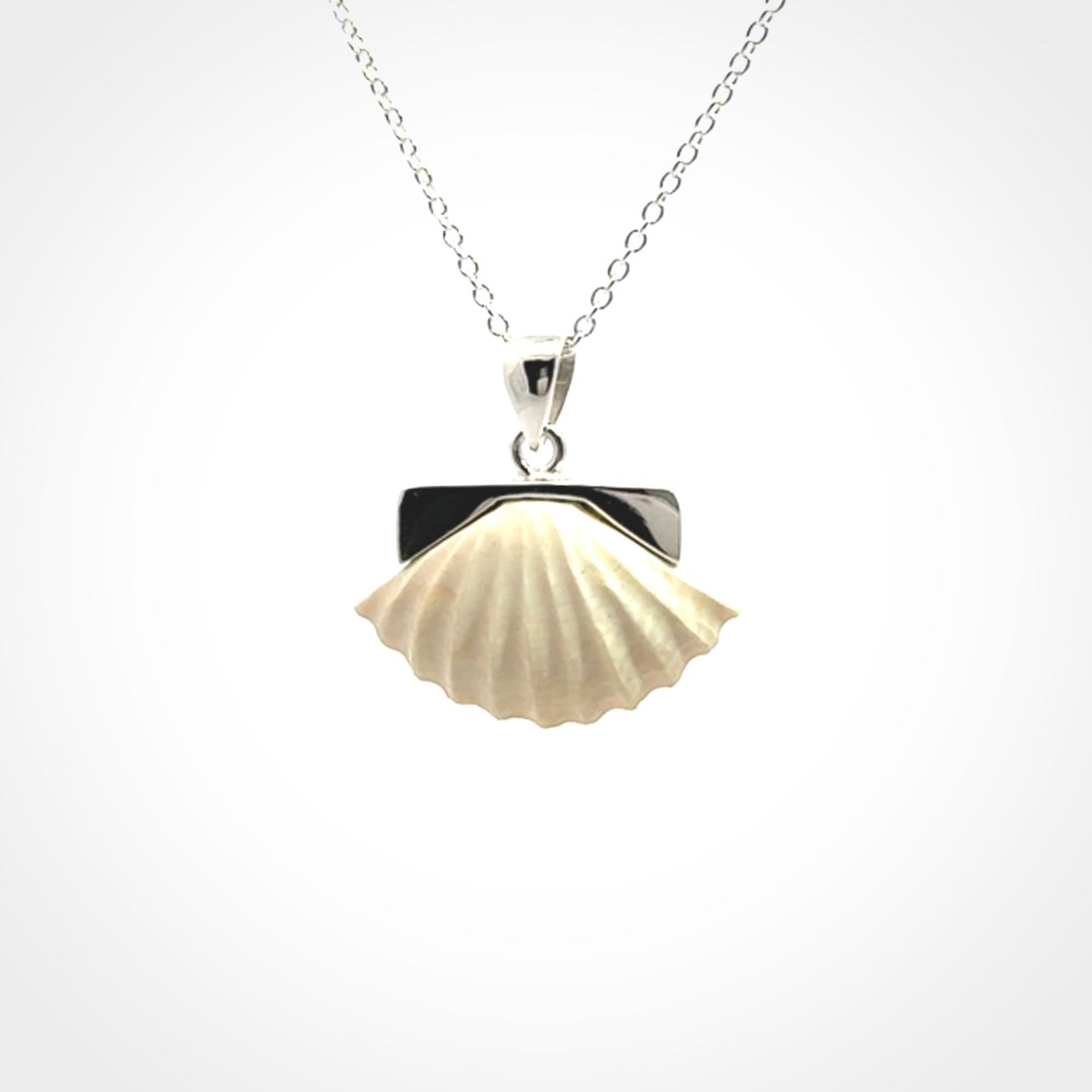 Hand made woolly mammoth tusk fanshell necklace with Sterling Silver. Mammoth tusk fanshell pendant with Sterling silver surround and chain. Made by NZ Pacific and sale online only.