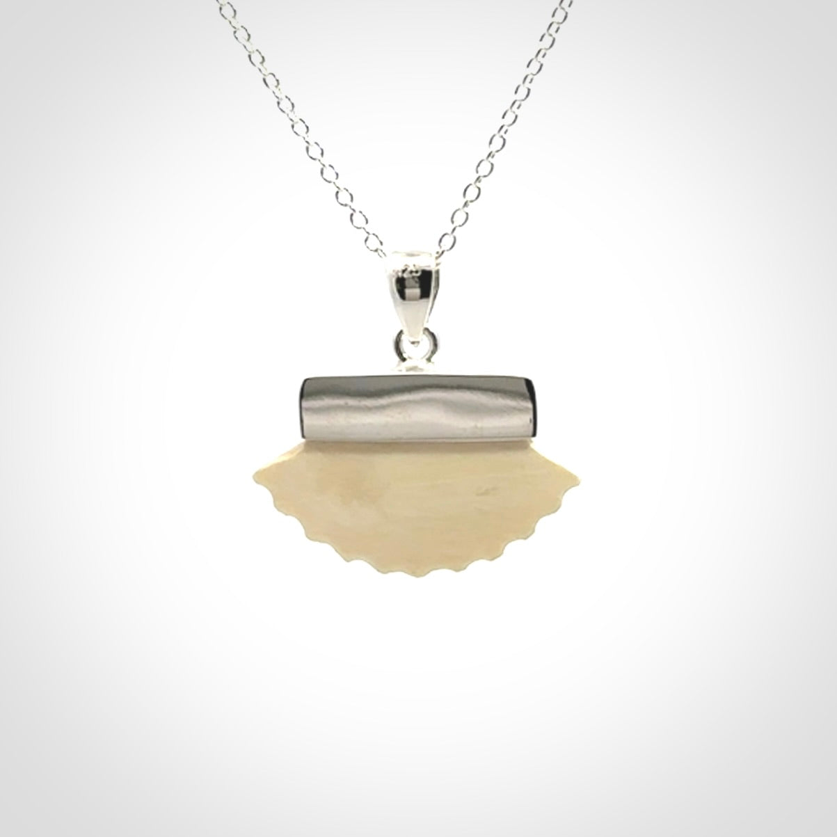 Hand made woolly mammoth tusk fanshell necklace with Sterling Silver. Mammoth tusk fanshell pendant with Sterling silver surround and chain. Made by NZ Pacific and sale online only.