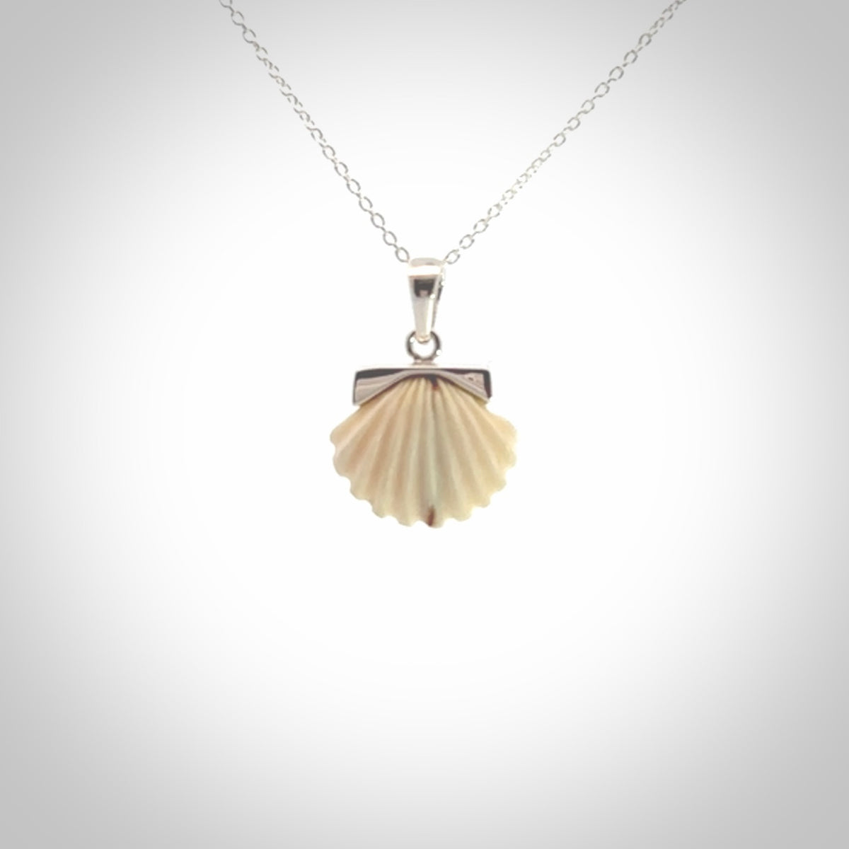 Hand made woolly mammoth tusk fanshell necklace with Sterling Silver. Mammoth tusk fanshell pendant with Sterling silver surround and chain. Made by NZ Pacific and sale online only.