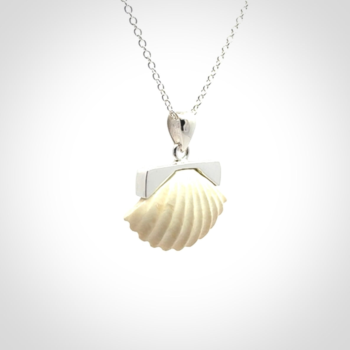 Hand made woolly mammoth tusk fanshell necklace with Sterling Silver. Mammoth tusk fanshell pendant with Sterling silver surround and chain. Made by NZ Pacific and sale online only.
