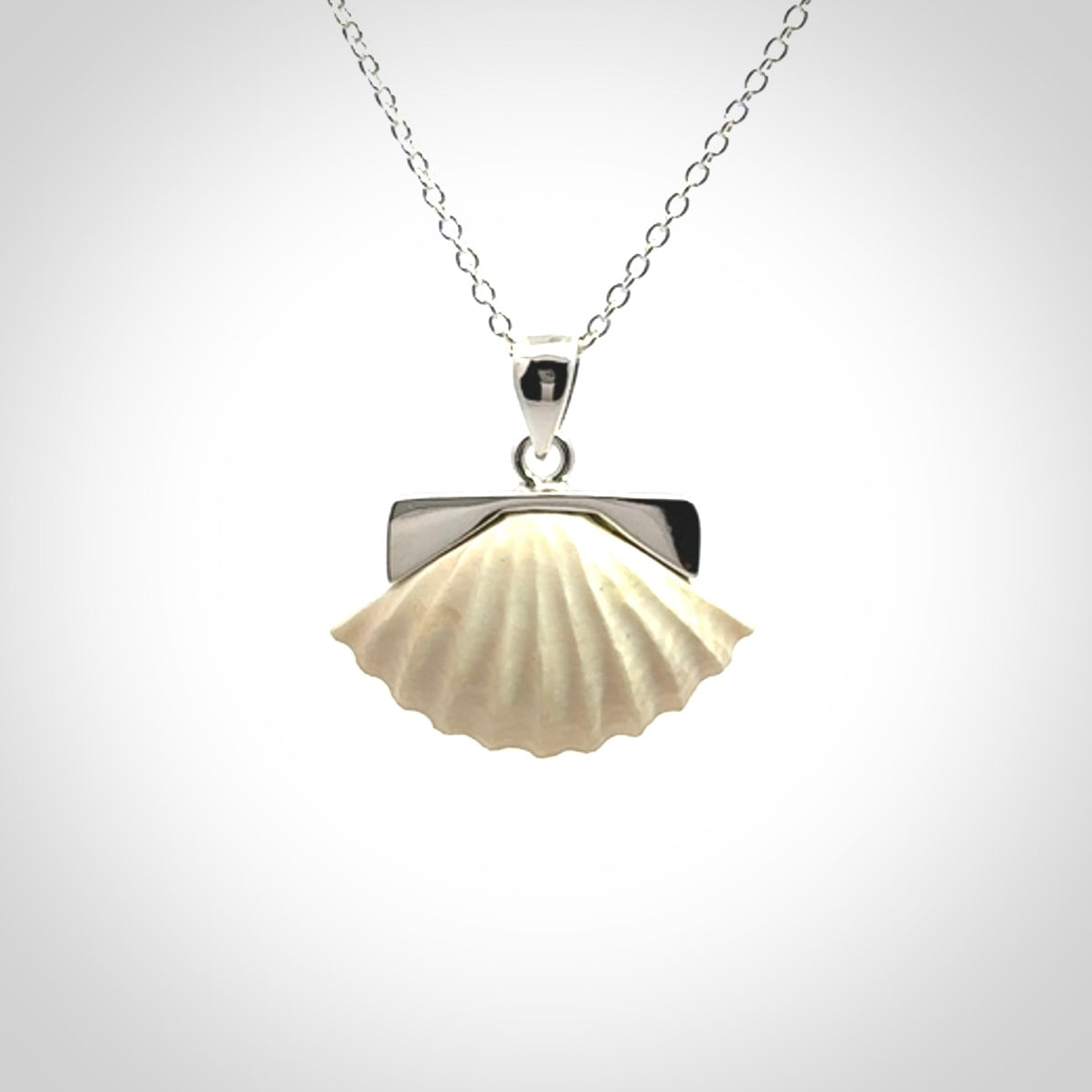 Hand made woolly mammoth tusk fanshell necklace with Sterling Silver. Mammoth tusk fanshell pendant with Sterling silver surround and chain. Made by NZ Pacific and sale online only.