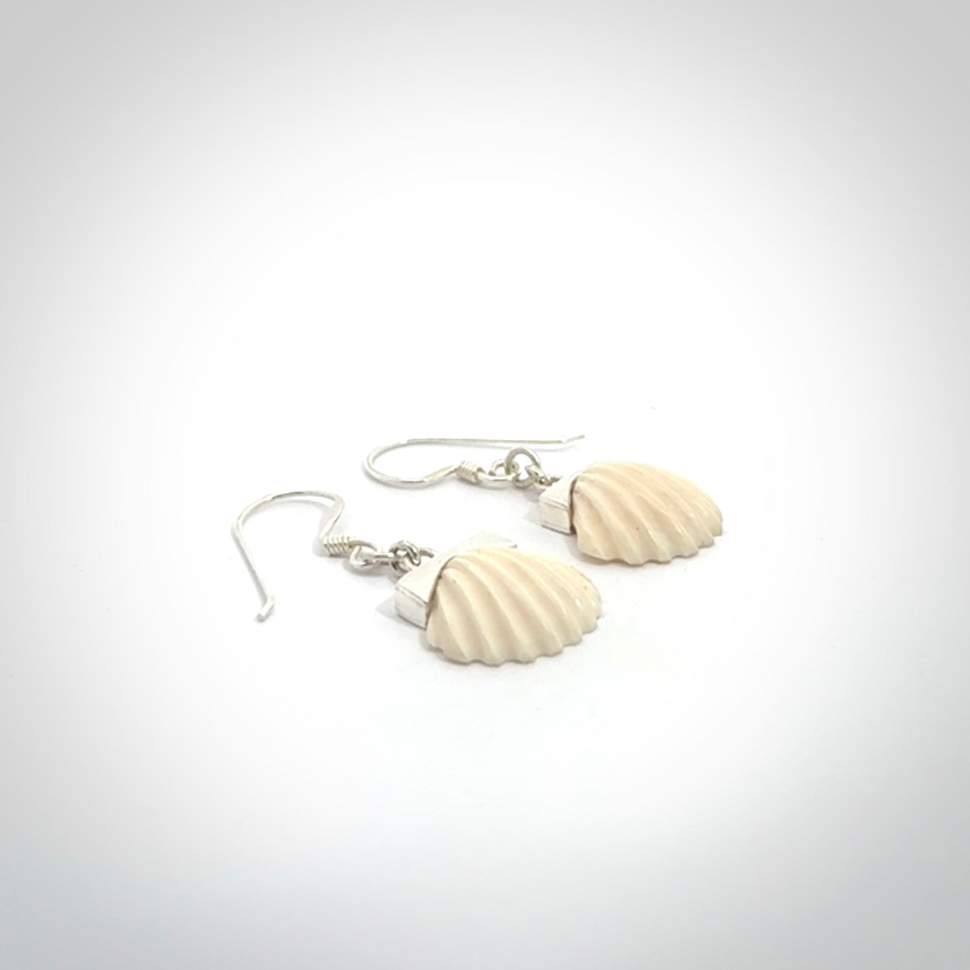 Hand made woolly mammoth tusk fanshell earrings with Sterling Silver. Mammoth tusk fanshell earrings with Sterling silver. Made by NZ Pacific and sale online only.