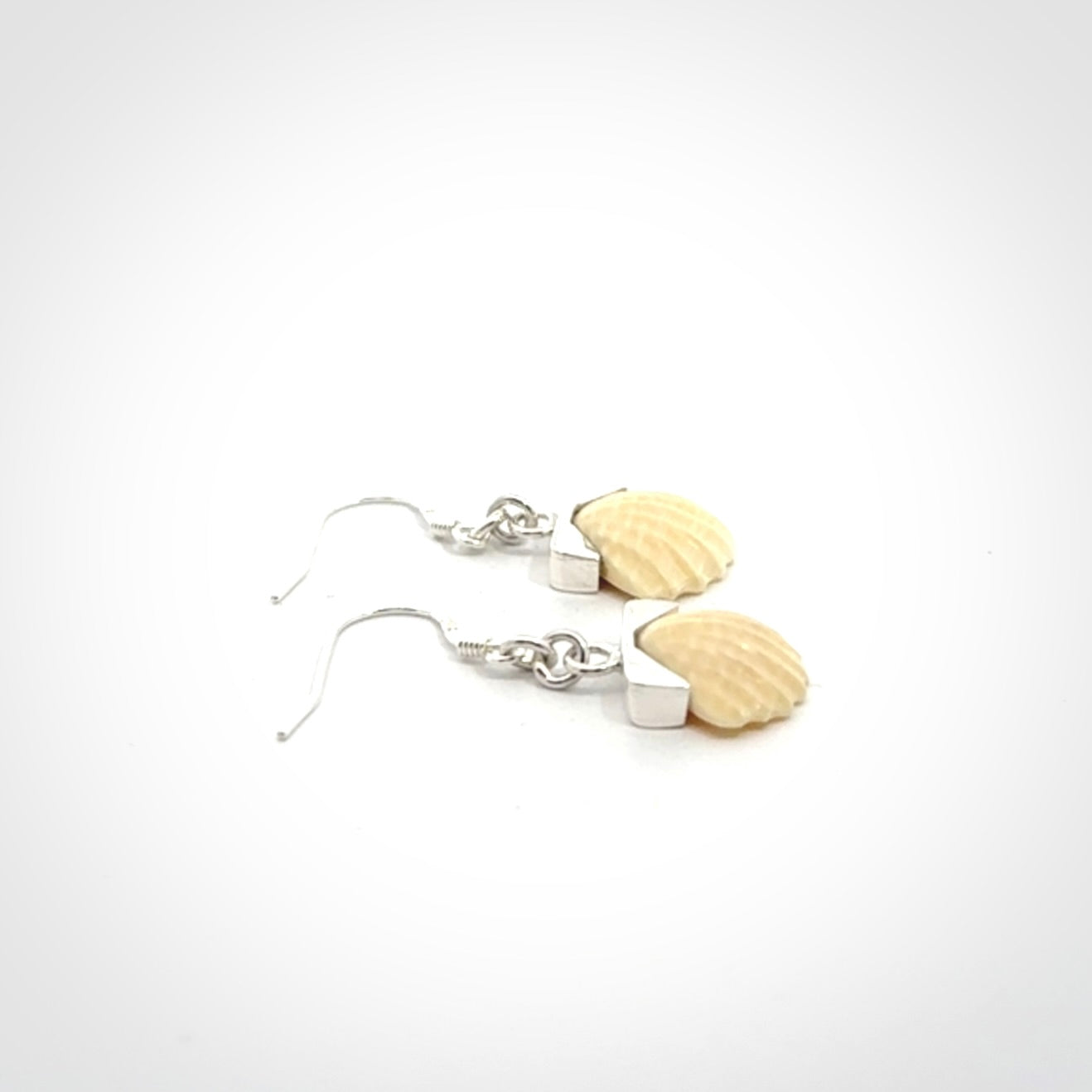 Hand made woolly mammoth tusk fanshell earrings with Sterling Silver. Mammoth tusk fanshell earrings with Sterling silver. Made by NZ Pacific and sale online only.