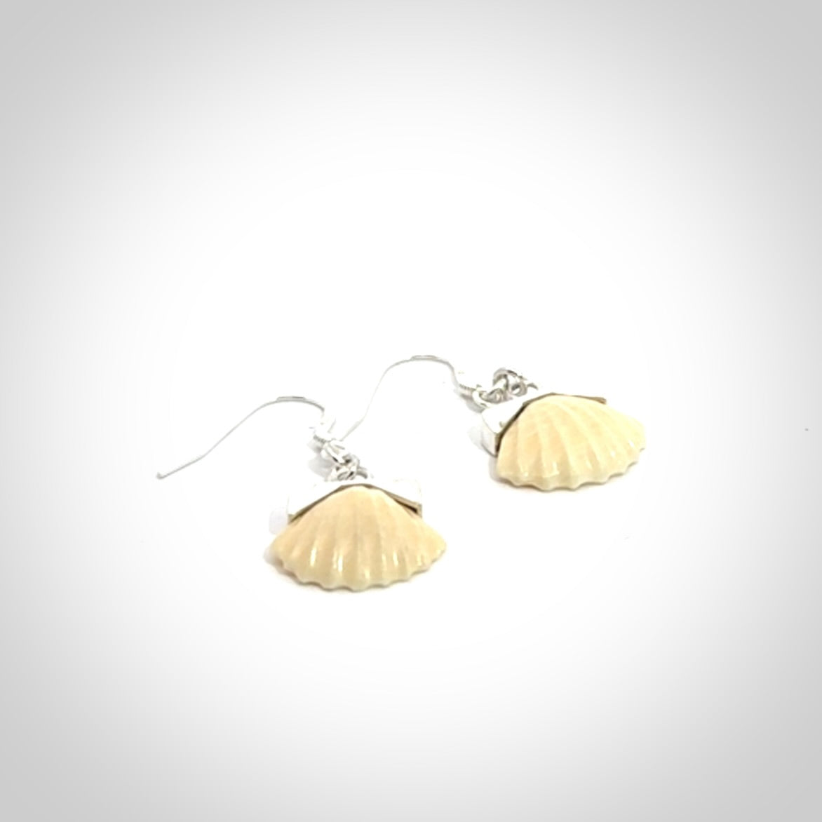 Hand made woolly mammoth tusk fanshell earrings with Sterling Silver. Mammoth tusk fanshell earrings with Sterling silver. Made by NZ Pacific and sale online only.