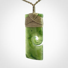 New Zealand jade toki koru pendant. Hand carved in New Zealand. Hand made jewellery. Provided with an adjustable cord.