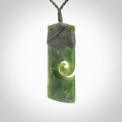 New Zealand jade toki koru pendant. Hand carved in New Zealand. Hand made jewellery. Provided with an adjustable cord.