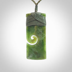 New Zealand jade toki koru pendant. Hand carved in New Zealand. Hand made jewellery. Provided with an adjustable cord.