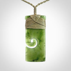 New Zealand jade toki koru pendant. Hand carved in New Zealand. Hand made jewellery. Provided with an adjustable cord.