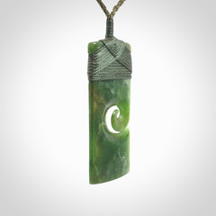 New Zealand jade toki koru pendant. Hand carved in New Zealand. Hand made jewellery. Provided with an adjustable cord.