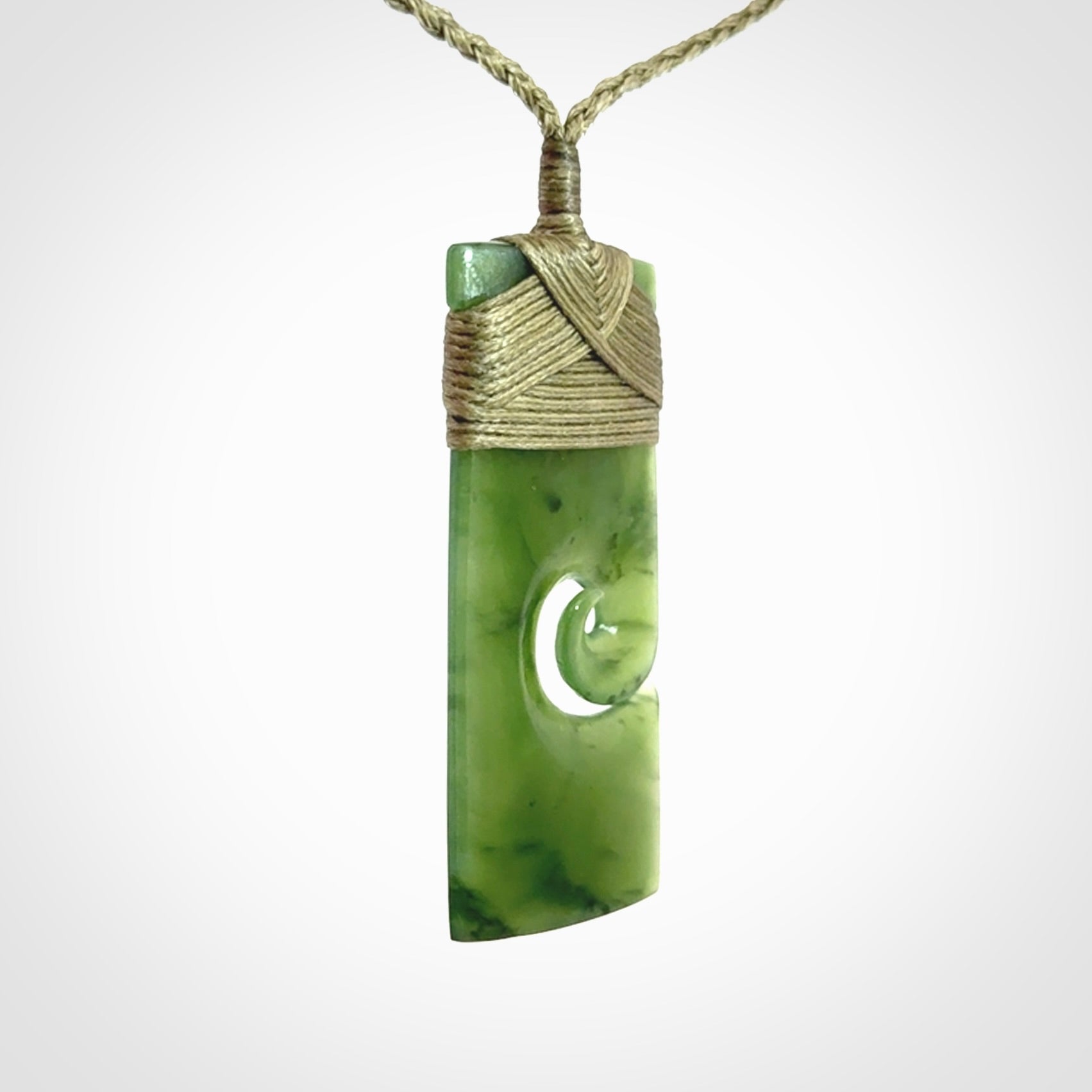 New Zealand jade toki koru pendant. Hand carved in New Zealand. Hand made jewellery. Provided with an adjustable cord.