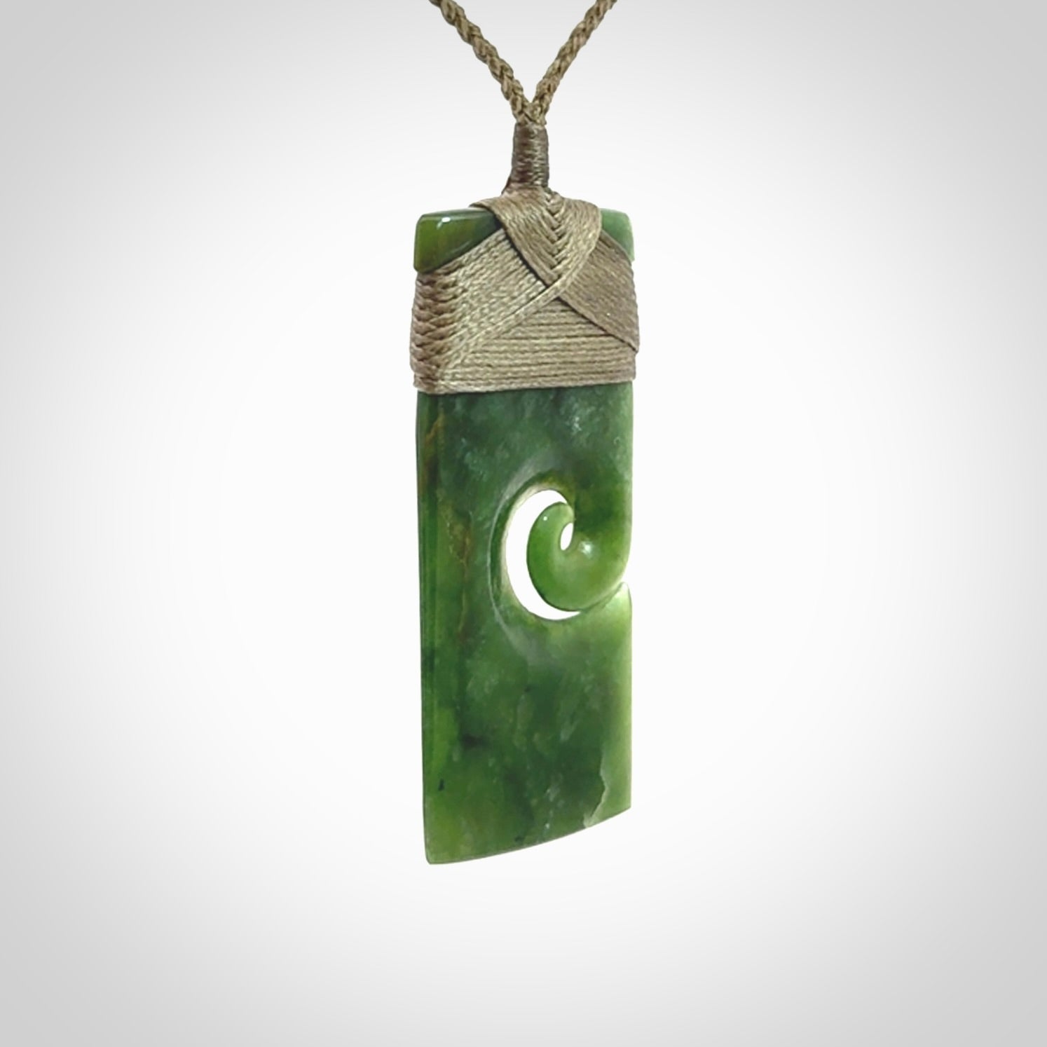 New Zealand jade toki koru pendant. Hand carved in New Zealand. Hand made jewellery. Provided with an adjustable cord.