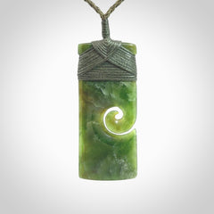 New Zealand jade toki koru pendant. Hand carved in New Zealand. Hand made jewellery. Provided with an adjustable cord.