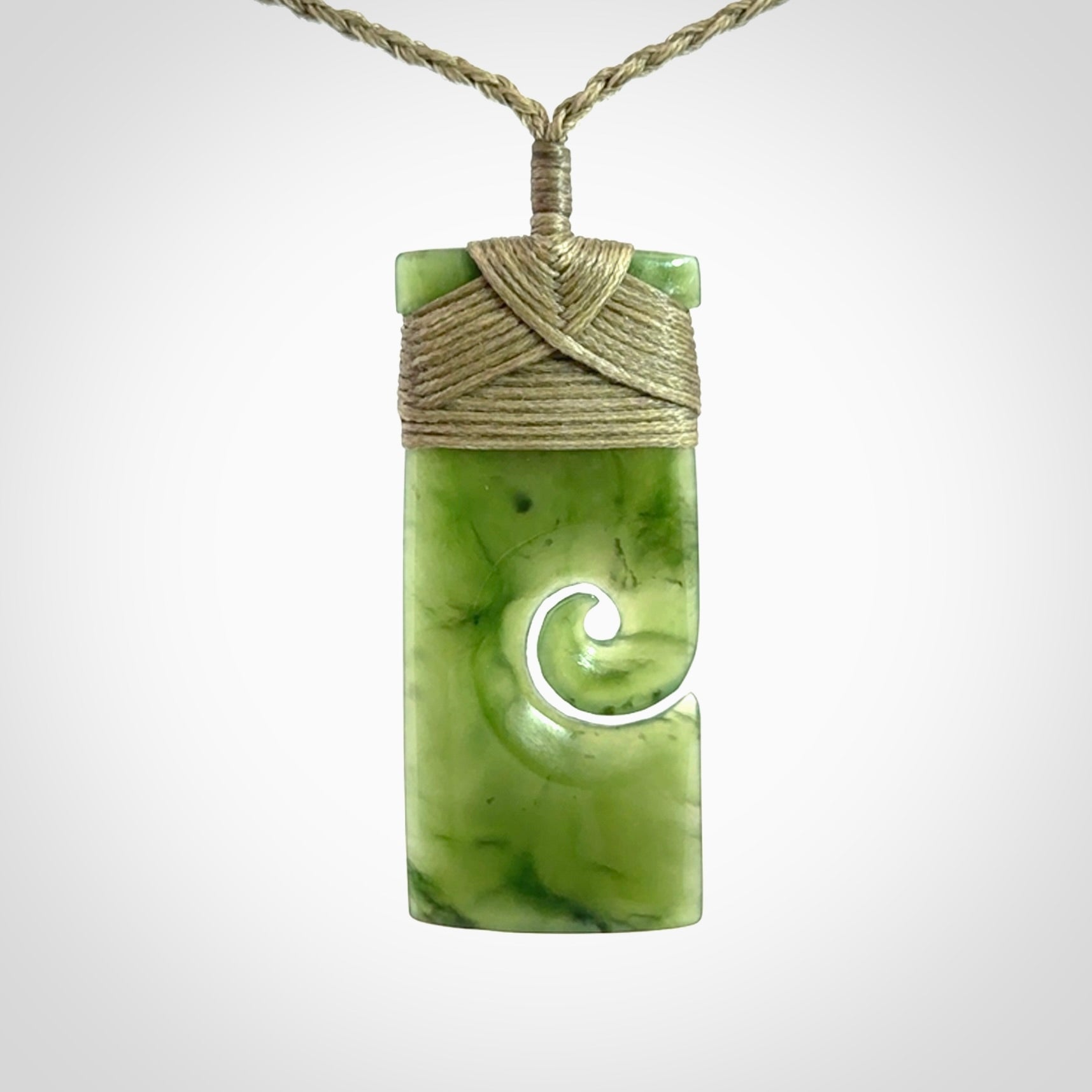 New Zealand jade toki koru pendant. Hand carved in New Zealand. Hand made jewellery. Provided with an adjustable cord.