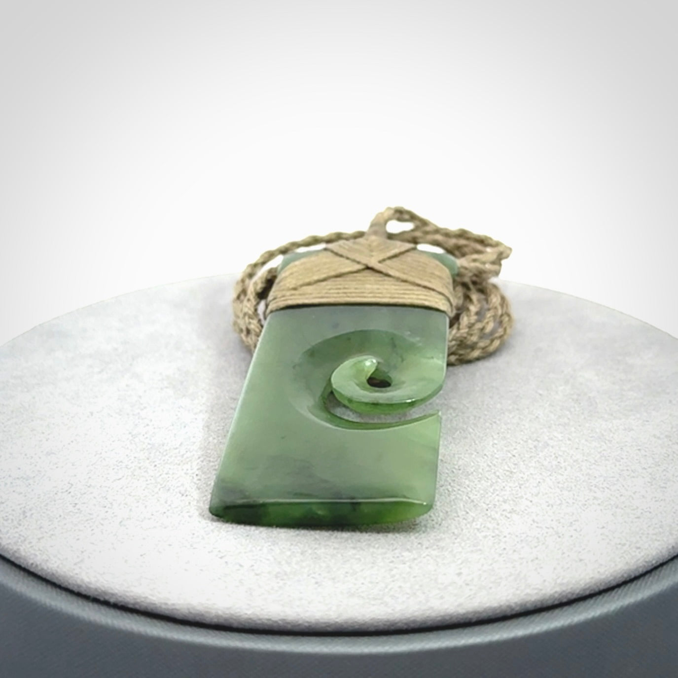 New Zealand jade toki koru pendant. Hand carved in New Zealand. Hand made jewellery. Provided with an adjustable cord.