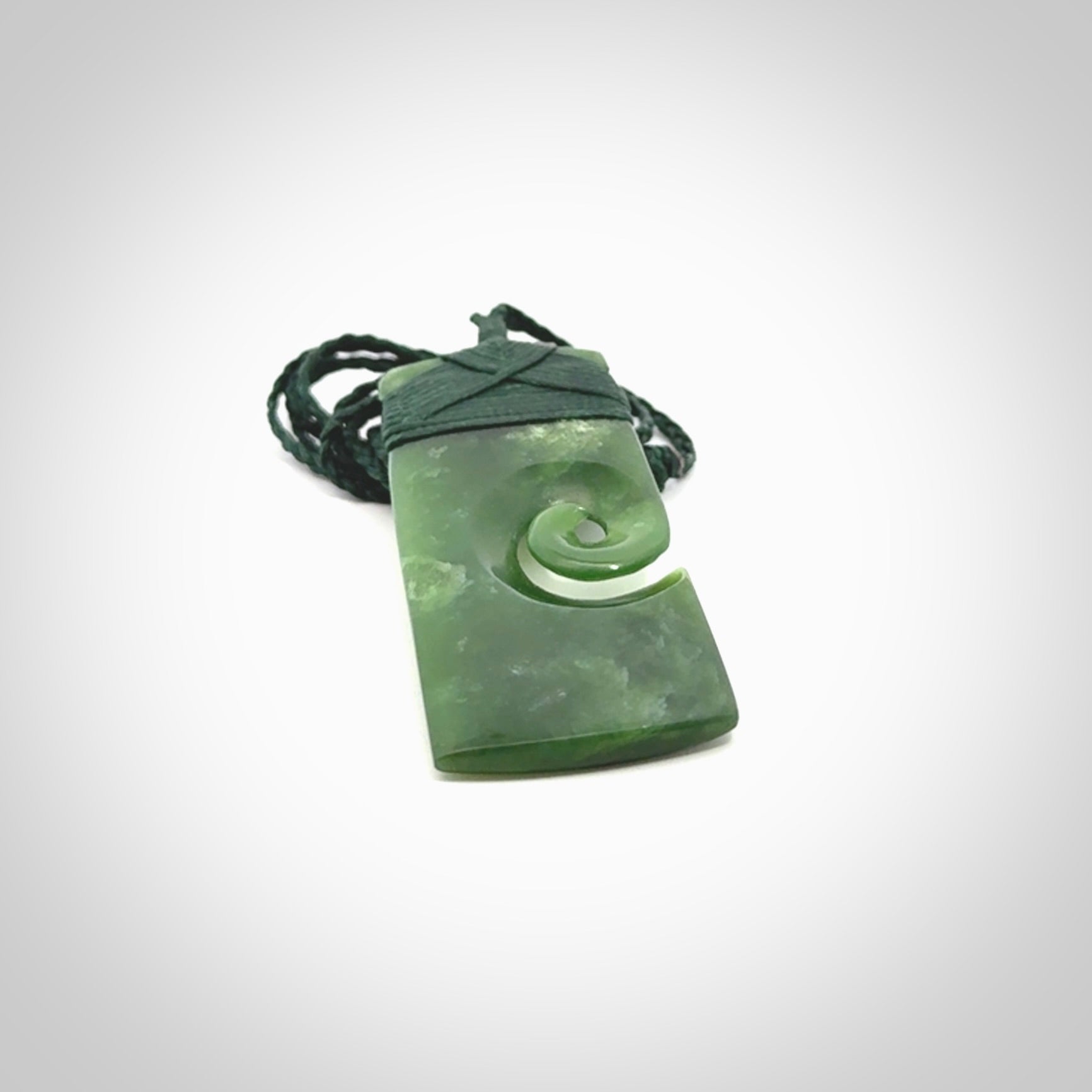 New Zealand jade toki koru pendant. Hand carved in New Zealand. Hand made jewellery. Provided with an adjustable cord.