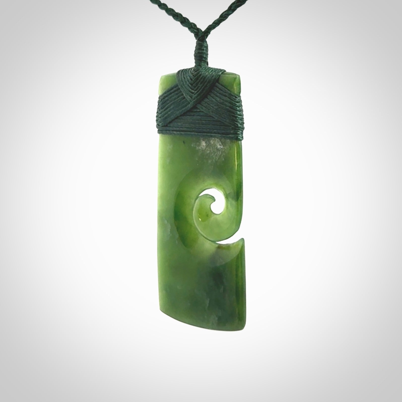 New Zealand jade toki koru pendant. Hand carved in New Zealand. Hand made jewellery. Provided with an adjustable cord.