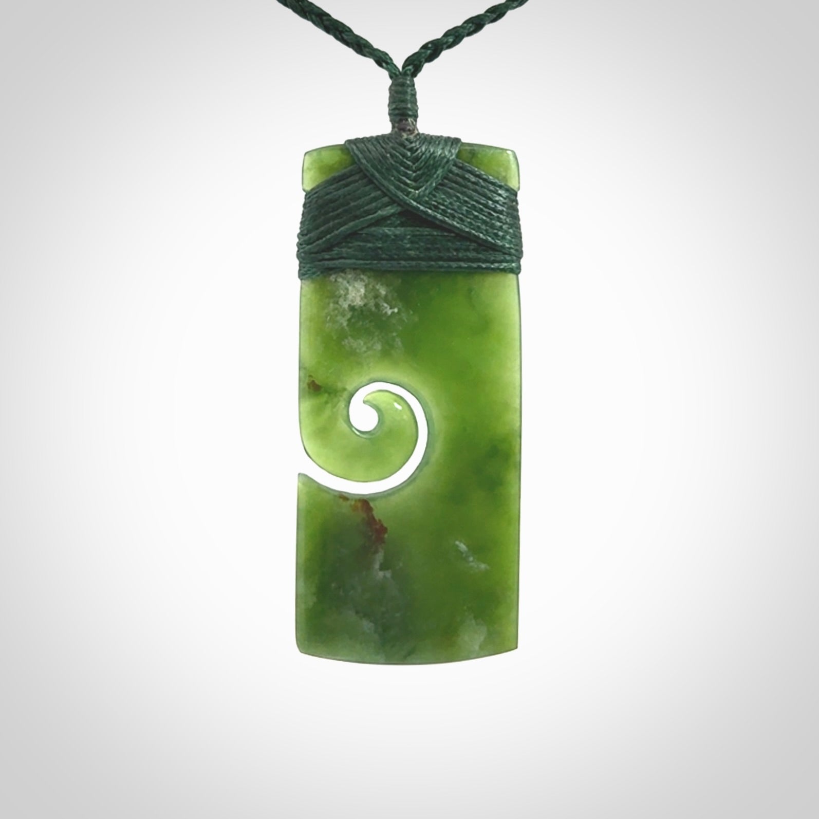 New Zealand jade toki koru pendant. Hand carved in New Zealand. Hand made jewellery. Provided with an adjustable cord.