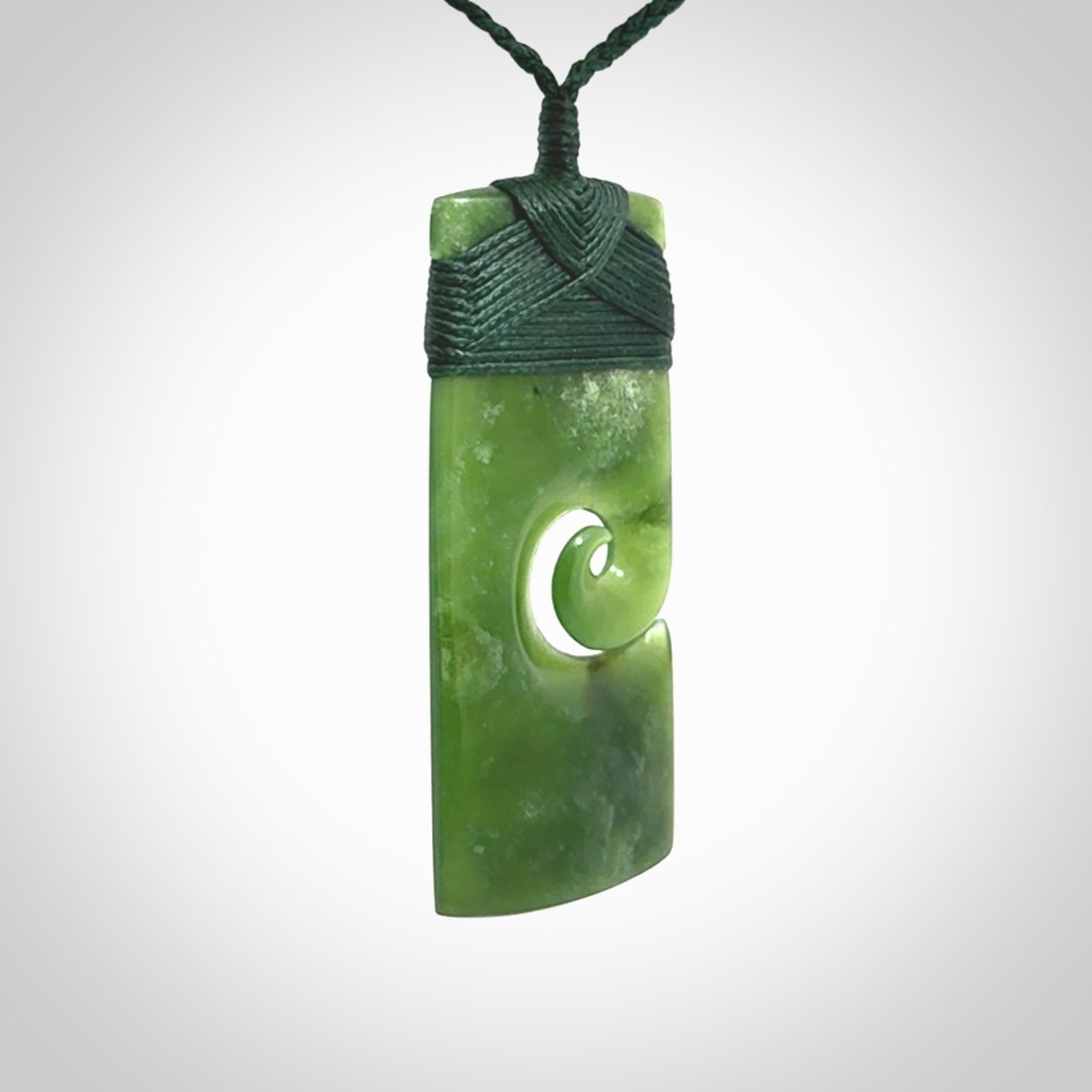 New Zealand jade toki koru pendant. Hand carved in New Zealand. Hand made jewellery. Provided with an adjustable cord.