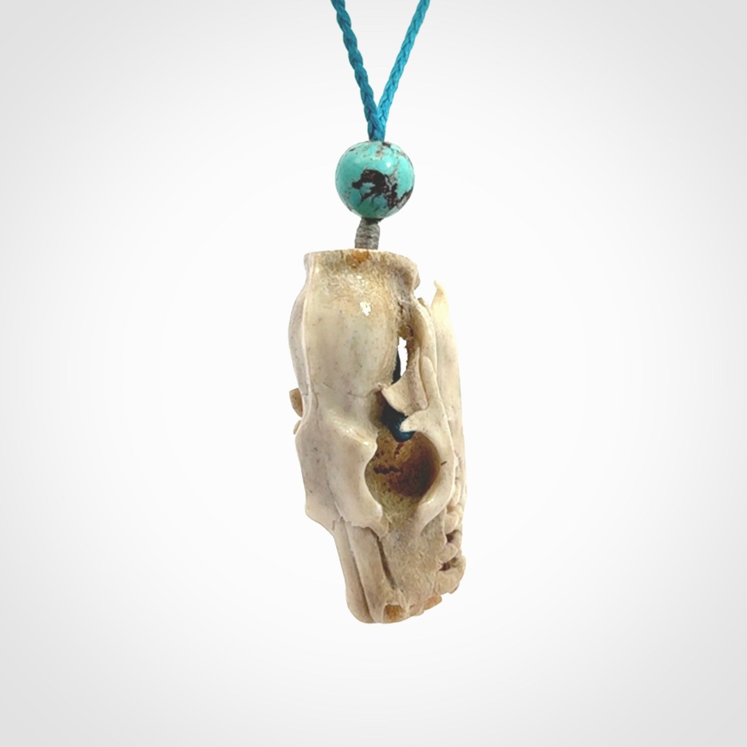 This is a hand carved deer antler cat skull pendant. It is made from deer antler, bone. This is a large sized necklace and is a very unique, one only, pendant that is a collectors piece. Hand carved deer antler cat skull necklace for men and women.