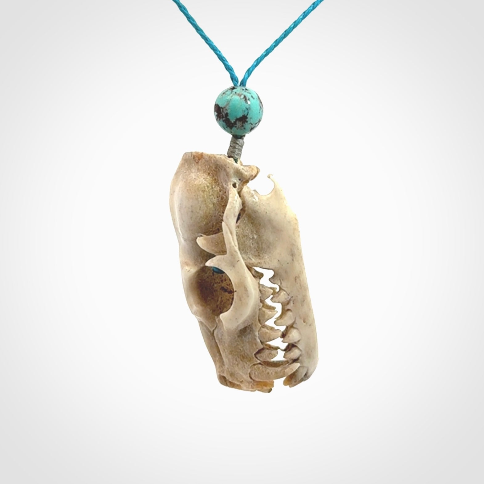 This is a hand carved deer antler cat skull pendant. It is made from deer antler, bone. This is a large sized necklace and is a very unique, one only, pendant that is a collectors piece. Hand carved deer antler cat skull necklace for men and women.