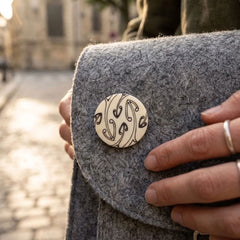 Woman with bone pin on her bag