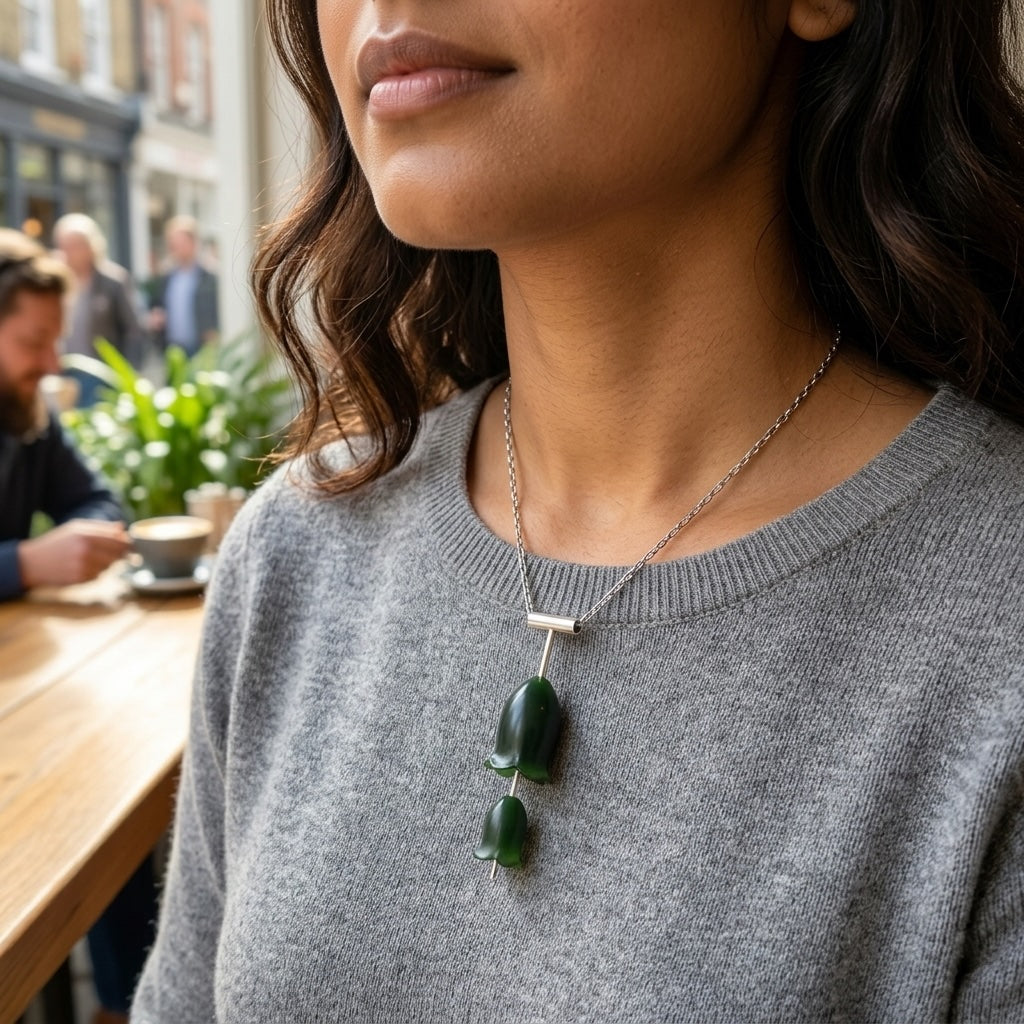 Woman wearing jade and silver flower necklace