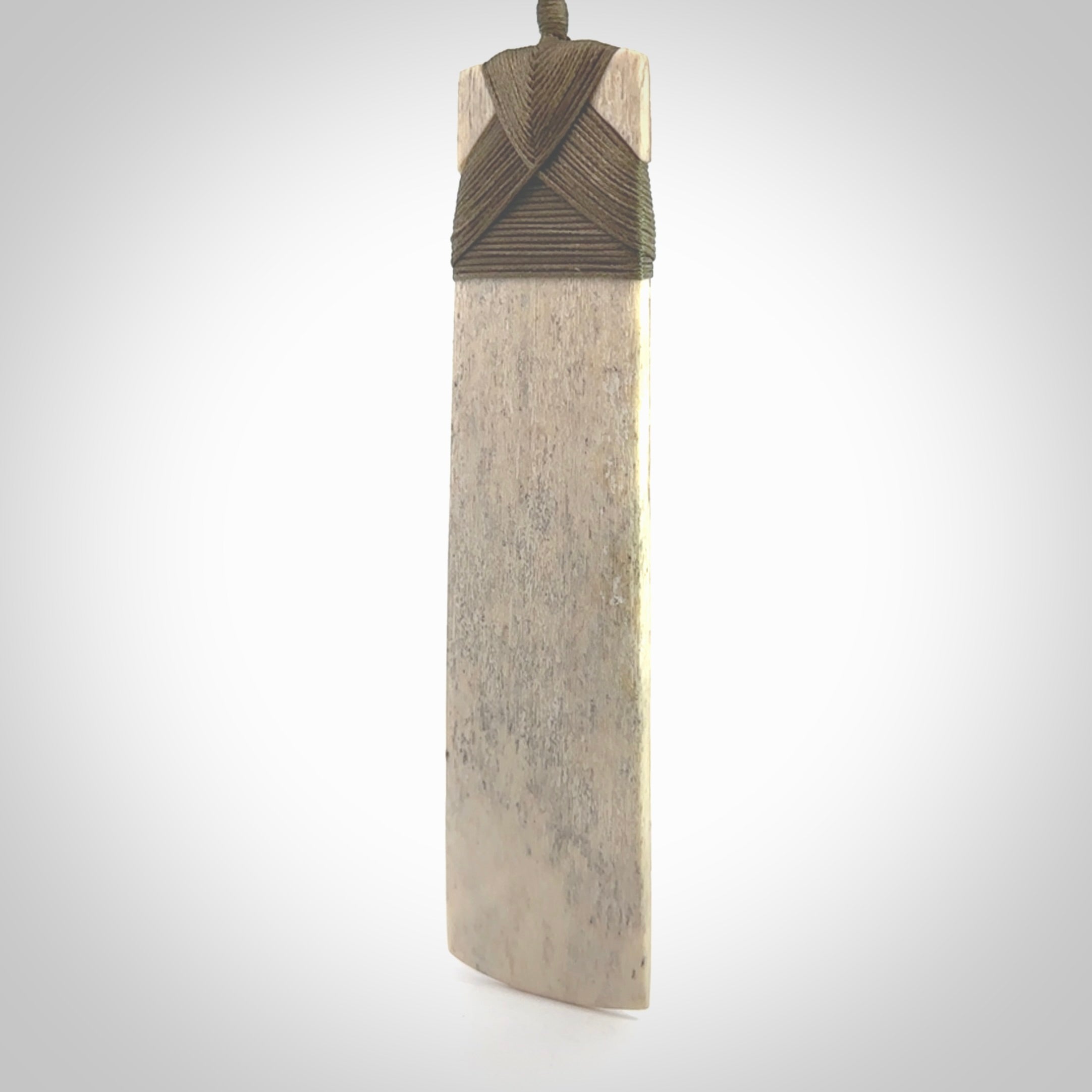Hand carved Whale Bone Toki by Fumio Noguchi. One only New Zealand whale bone toki necklace for men and women. Unique New Zealand art to wear. Shipped to you on an adjustable cord.