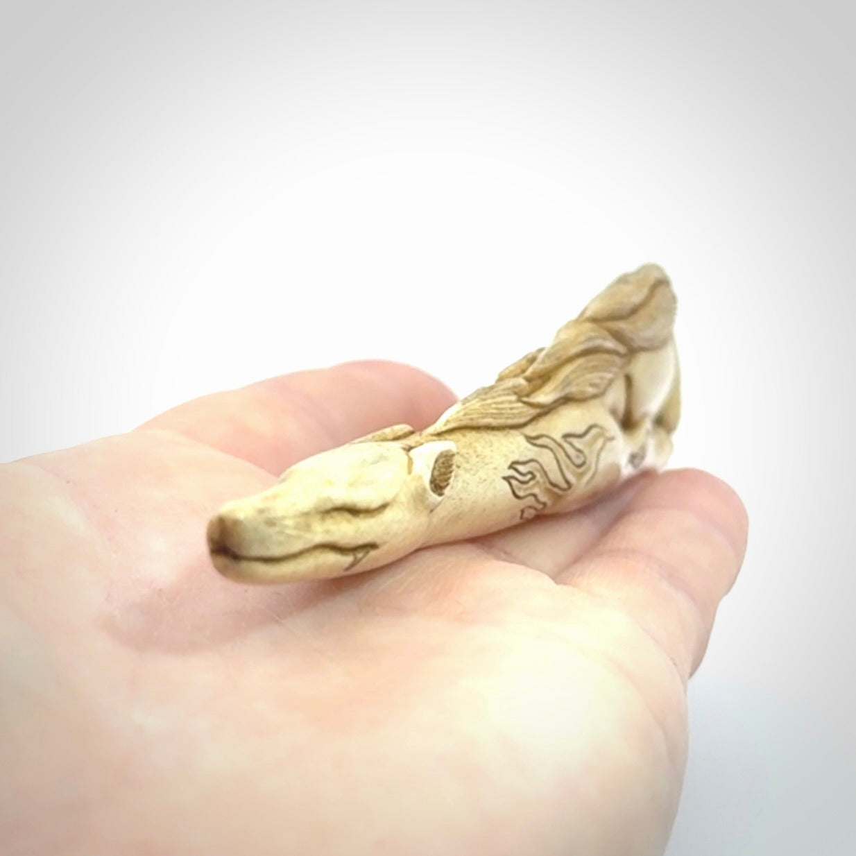 Hand carved incredible nine-tailed fox bone carving. A stunning work of art, beautifully replicating a nine-tailed fox. A one off collectors item that has been hand crafted to be worn or displayed.