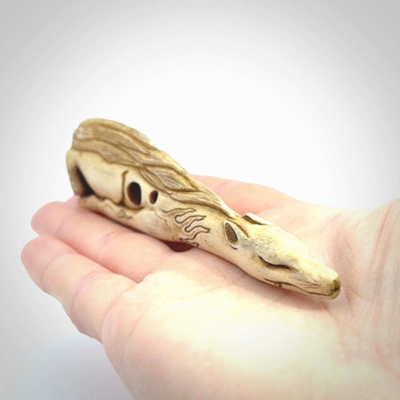 Hand carved incredible nine-tailed fox bone carving. A stunning work of art, beautifully replicating a nine-tailed fox. A one off collectors item that has been hand crafted to be worn or displayed.