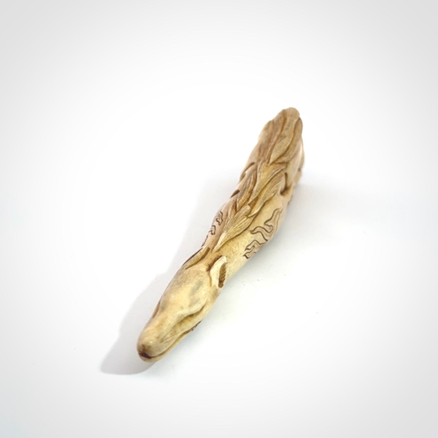Hand carved incredible nine-tailed fox bone carving. A stunning work of art, beautifully replicating a nine-tailed fox. A one off collectors item that has been hand crafted to be worn or displayed.