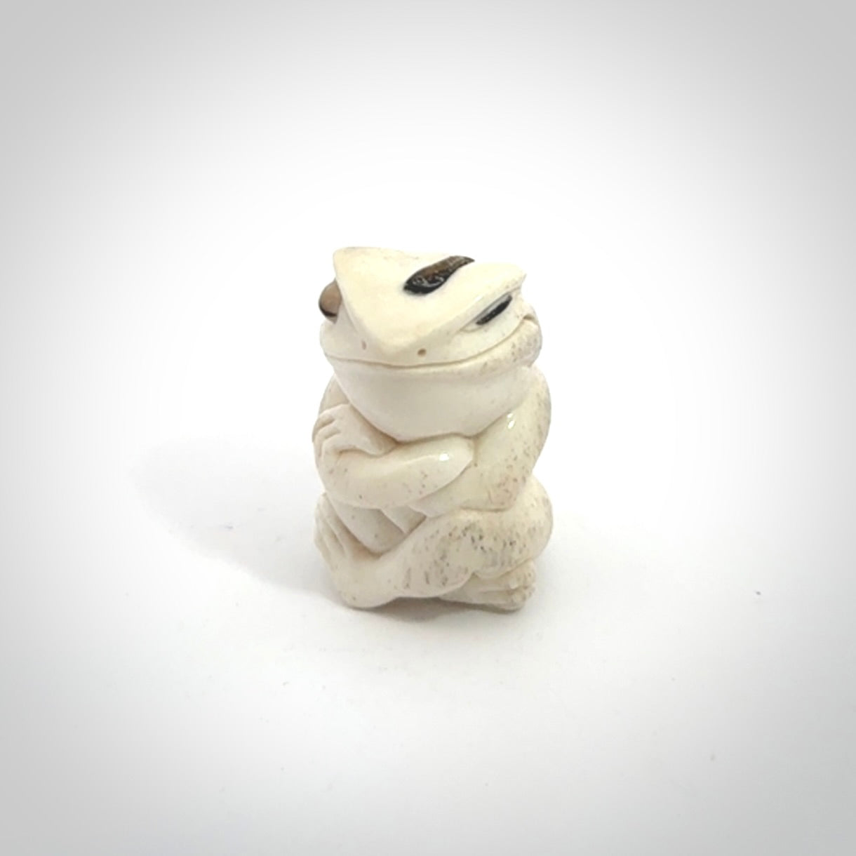 Hand carved meditating frog with slug on its head, made from Deer antler and black mother of pearl. Hand made by master bone carver Fumio Noguchi. Spectacular collectable work of art to display. One only, delivered to you at no extra cost with express courier.