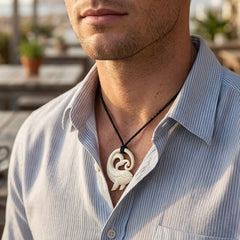 Man wearing bone whale pendant