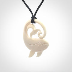 A hand carved bone whale pendant. This is a lovely piece carved to bring pleasure to the lucky wearer. It is a friendly pendant which we will ship to you free wherever you live. Carved by NZ Pacific and for sale online. Provided with an adjustable dark blue cord.