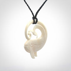A hand carved bone whale pendant. This is a lovely piece carved to bring pleasure to the lucky wearer. It is a friendly pendant which we will ship to you free wherever you live. Carved by NZ Pacific and for sale online. Provided with an adjustable dark blue cord.