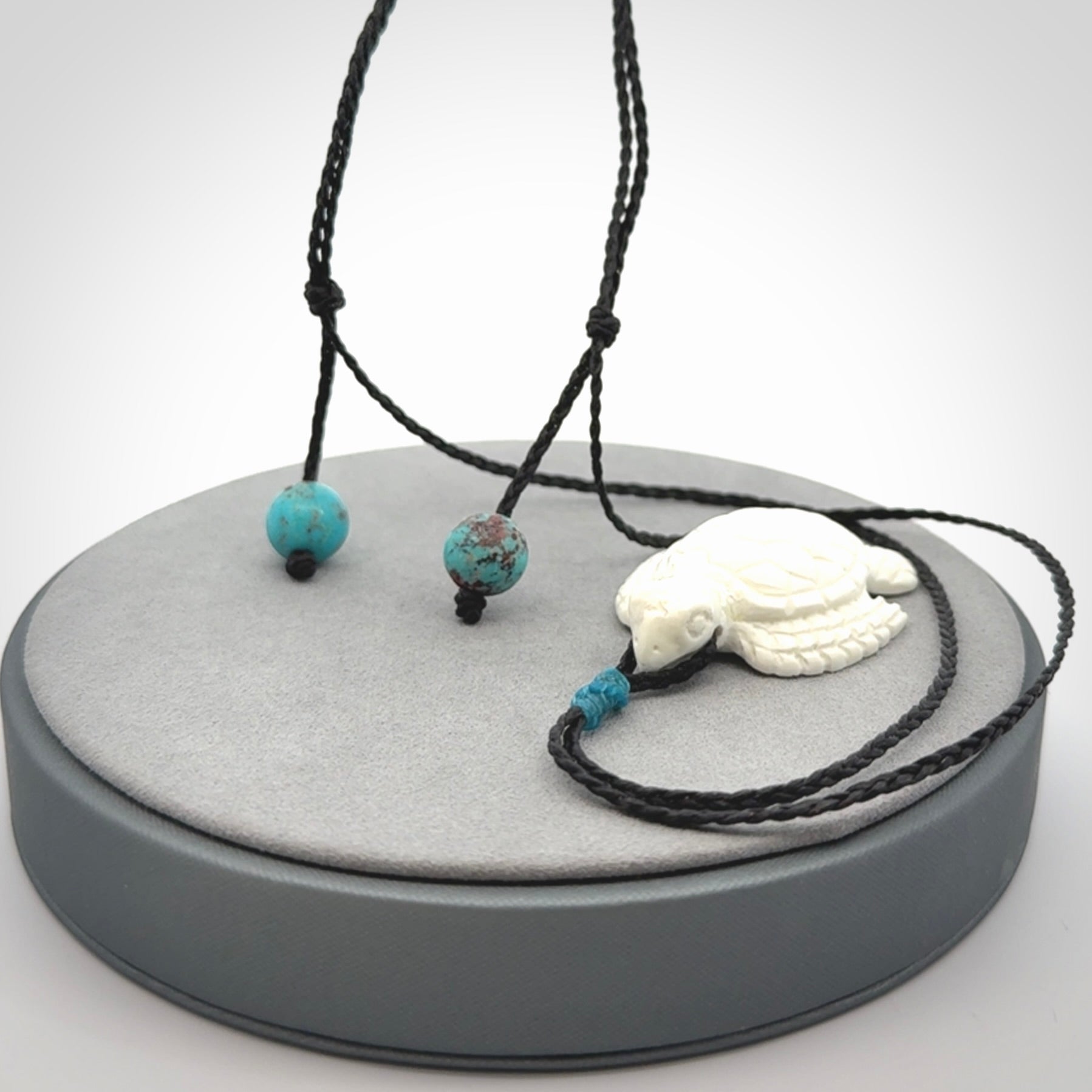 Hand carved white onyx turtle pendant. Unique handmade jewellery for sale online.