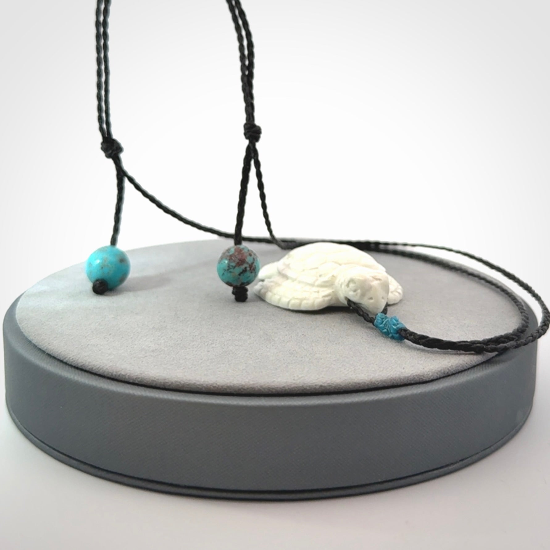 Hand carved white onyx turtle pendant. Unique handmade jewellery for sale online.