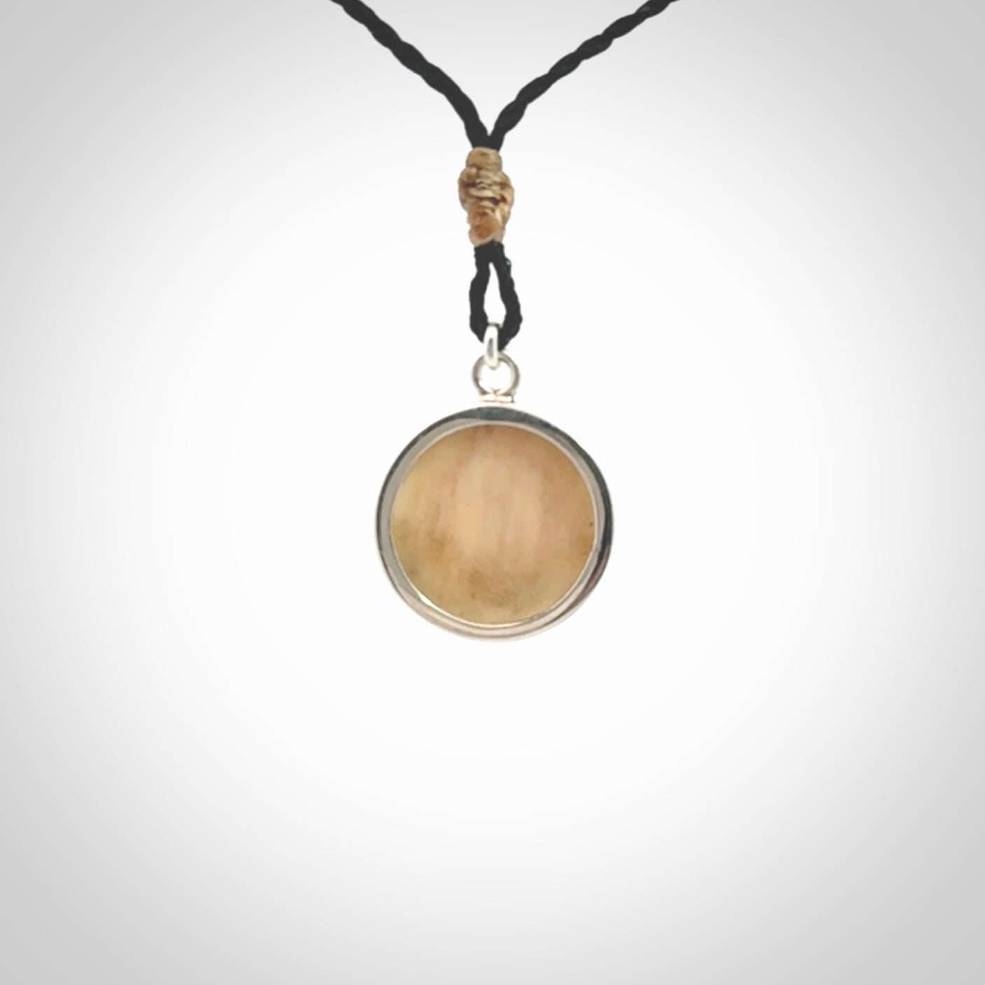 Hand made woolly mammoth tusk moon face necklace. Made by NZ Pacific and sale online only. Delivered with adjustable cord and packaged in a woven kete pouch.