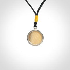Hand made woolly mammoth tusk moon face necklace. Made by NZ Pacific and sale online only. Delivered with adjustable cord and packaged in a woven kete pouch.