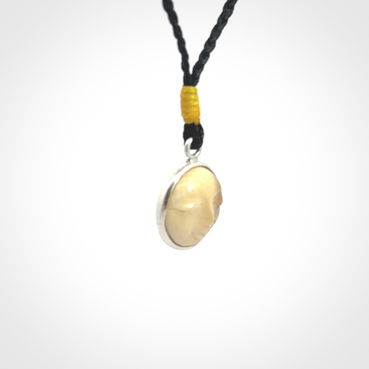 Hand made woolly mammoth tusk moon face necklace. Made by NZ Pacific and sale online only. Delivered with adjustable cord and packaged in a woven kete pouch.