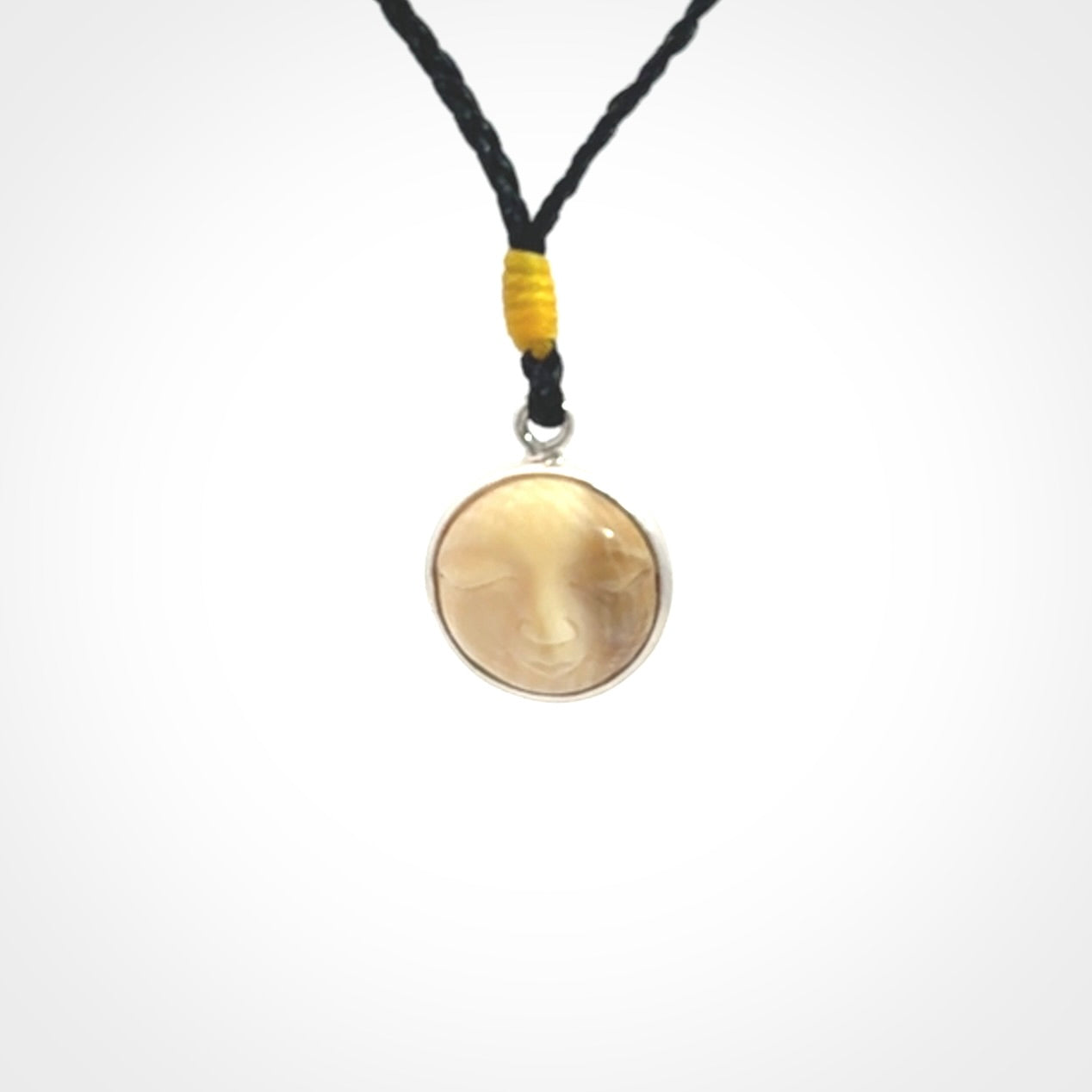 Hand made woolly mammoth tusk moon face necklace. Made by NZ Pacific and sale online only. Delivered with adjustable cord and packaged in a woven kete pouch.