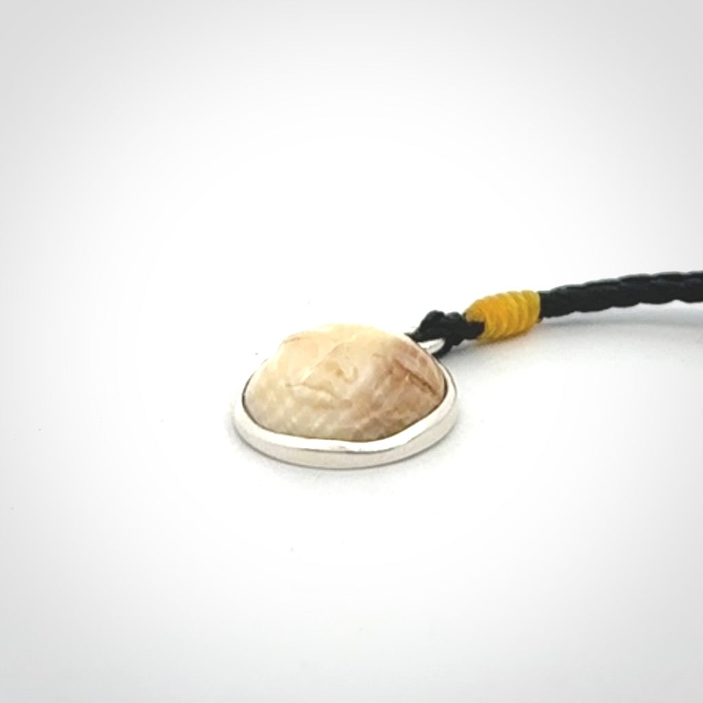 Hand made woolly mammoth tusk moon face necklace. Made by NZ Pacific and sale online only. Delivered with adjustable cord and packaged in a woven kete pouch.