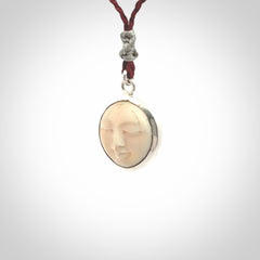 Hand made woolly mammoth tusk moon face necklace. Made by NZ Pacific and sale online only. Delivered with adjustable cord and packaged in a woven kete pouch.