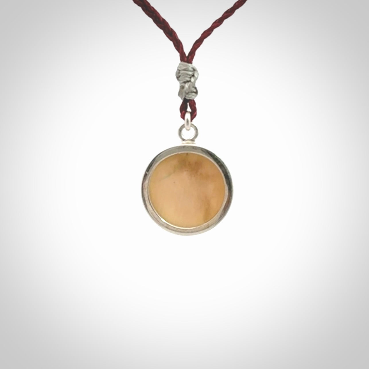 Hand made woolly mammoth tusk moon face necklace. Made by NZ Pacific and sale online only. Delivered with adjustable cord and packaged in a woven kete pouch.