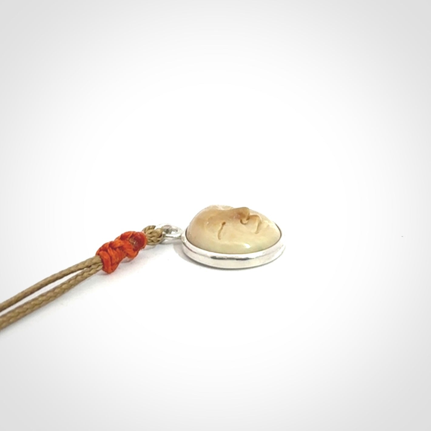 Hand made woolly mammoth tusk moon face necklace. Made by NZ Pacific and sale online only. Delivered with adjustable cord and packaged in a woven kete pouch.